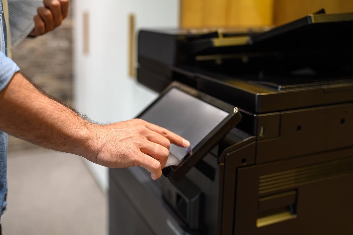 Businessman operating modern printer